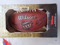 Wilson Official NFL Super Bowl XXXI football in original display box showing front and logo details.
