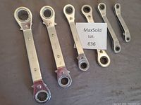 Six Imperial ratchet wrenches of various sizes laid out together, showing both ends where ratchets are located. Five wrenches have angled ends with ratchet levers visible; one wrench is straight with ratchets on each end.