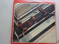 Front cover of The Beatles '1962-1966' double vinyl album showing band members in photo with red border and white title text.