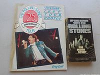 Photo showing two books about The Rolling Stones, one with a color image of Mick Jagger on stage, the other a black and white cover titled 'Up and Down with the Rolling Stones'