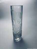 Full view of tall clear crystal vase with etched swirl pattern.