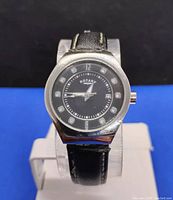 Front view of Rotary women's wristwatch with black dial and leather strap.