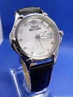 Front view of the watch showing the Swiss Military logo on the white dial, date window, and black leather strap.