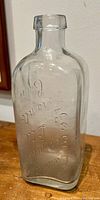 Clear glass antique bottle embossed with company name 'Canadian Germicide Toronto Can.' showing front and shape details.