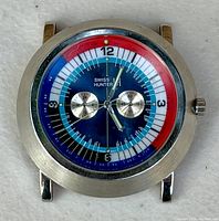 Front view of vintage Swiss Hunter wristwatch showing blue, red, white dial with two silver subdials and hands.