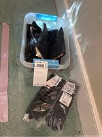 Image showing four black gloves in a plastic container with three pairs of black gloves in original packaging labeled J Jill, size S/M.