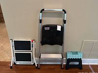 All three step stools shown standing next to wall and each other, highlighting their size and structure.