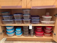 Photo showing three rows of plastic containers in cabinet, with various colors of lids including dark blue, purple, red, and light blue