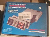 Box showing the Mini Game Anniversary Edition console with 620 built-in games and wired controller image