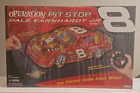 Front box image showing game title, Dale Earnhardt Jr. edition text, and graphical NASCAR racecar with pit stop parts labeled.