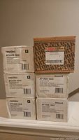 Stack of five Honeywell Resideo AT140A 1042 transformers boxed, with one additional transformer in brown box