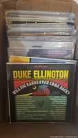 Photo of vintage vinyl records stacked in a box, front record is Duke Ellington's album titled 'Will Big Bands Ever Come Back?'