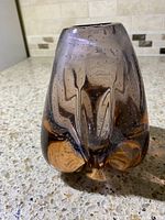 Front view of purple art glass vase showing bubble pattern and organic base shape.