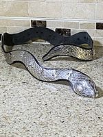 Full view of silver-tone metal snake belt laid out with coiled shape visible