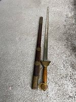 Full view of the samurai sword and its holder on ground showing length and details