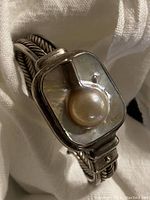 Close-up image of the blister pearl set on a square mother-of-pearl base with detailed twisted silver band showing the heavy weight sterling silver 925 hallmark.