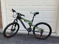 Side view of bicycle leaning against garage door showing full frame and wheel profile