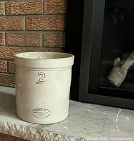Front view of the vintage pottery crock with size and branding visible