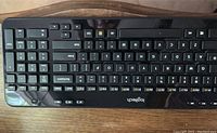 Top-down view of the Logitech wireless keyboard showing all keys including numeric keypad and media buttons.