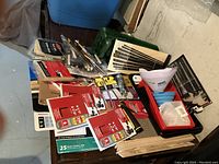 Top view showing assorted paint tools including brushes, sandpaper, and tack cloths.