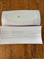 Top and bottom views of the first Verdici rectangular platter showing the black line design and brand mark on the bottom