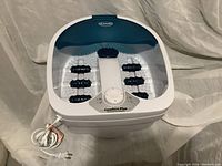 Front view of Dr. Scholl’s Comfort Plus foot bath showing overall device, power cord, and control knob.