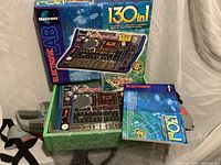 Photo of Maxitronix Electronic Lab 130-in-1 kit with circuit board, box, and manual as included in lot.