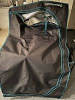 Black Mars Hydro grow tent fabric with teal accent trim and zippered door partially opened showing reflective interior lining.