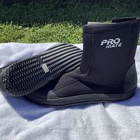 Side and sole view of black Promate wetsuit boots showing zipper and treaded rubber sole