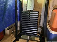 Weight stack machine with black metal frame and weight plates