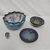 Front view of all ceramic pieces showing size differences and glaze details