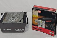 Garage door opener and heat gun together, showing box for heat gun and opener unit.