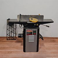 Front view showing infeed/outfeed tables, cutter head guard, control panel and main housing.