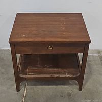 Front view of side table with drawer closed showing top surface wear