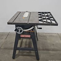 Front view of Craftsman 10-inch table saw showing metal tabletop, handwheels, and lattice extension arm.