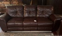Front view of full dark brown reclining sofa
