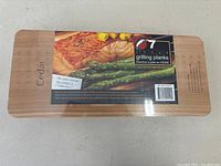 Top side of the cedar grilling planks package showing 7 cedar planks for grilling and instructions