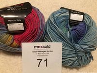 Two balls of Knit One Crochet Too Ty-Dy cotton yarn showing color and packaging labels, placed with auction number card.