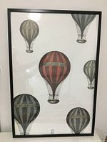 Front view of the 25 x 37 inch framed hot air balloon poster showing multiple vintage-style hot air balloons on white background in IKEA Ribba frame.