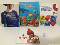 Front covers of the four crochet books, nicely arranged and visible titles and images.