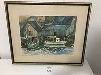 Full view of the framed watercolor painting showing boats docked at buildings alongside water, in muted blue and gray tones.