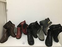 Six pairs of women's ankle boots in size 6.5/7 displayed side by side showing color and styles variation