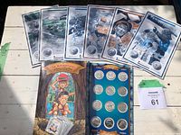 Full display of 6 story and game booklets, hardcover storybook, and coin display card with coins visible