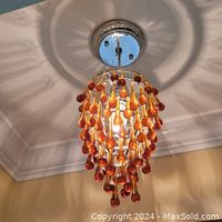 Fixture installed on ceiling, showing full length and light pattern on ceiling.