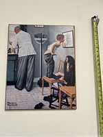 Photo shows a 16x20 print framed or unframed, depicting a classic Norman Rockwell style scene in a doctor's office with a doctor, medical scale, two children, one child standing on a chair.