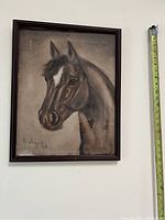 Framed painting showing a horse's head and neck, signed and dated bottom left corner, with a measuring tape beside frame indicating size about 16 by 20 inches.