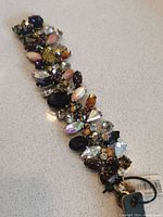 Photo of new J.Crew women's bracelet showing multi-colored stones and tags attached