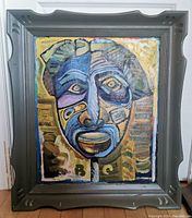Full view of original oil painting framed showing an abstract face with bold colors and geometric shapes.