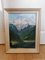Frontal photo of the framed mountain landscape oil painting showing whole artwork and frame.