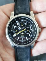 Front view of U.S. Army branded men's wristwatch with black dial and tachymeter scale.